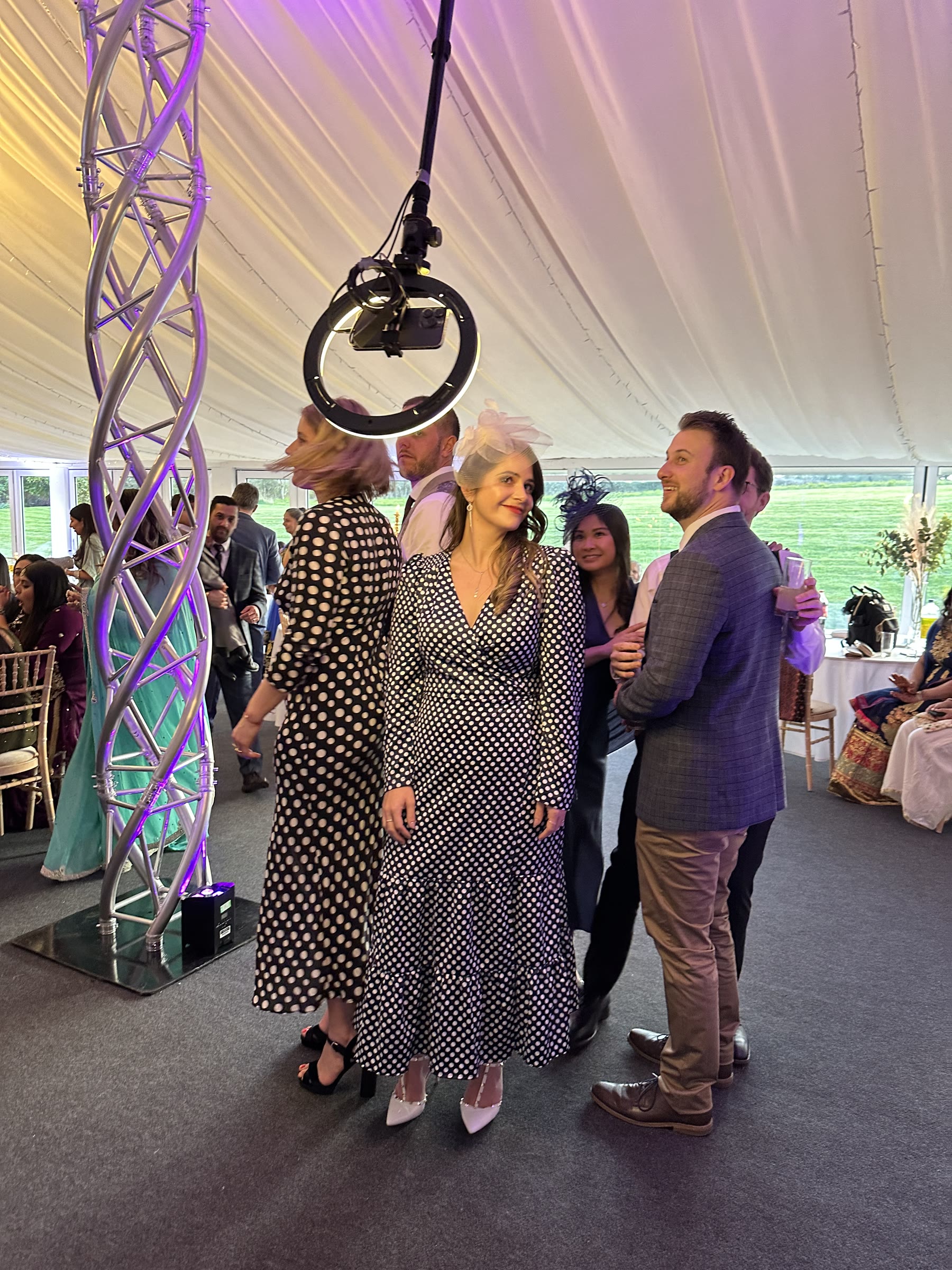 Wedding guests posing beneath the rotating 360 degree video camera