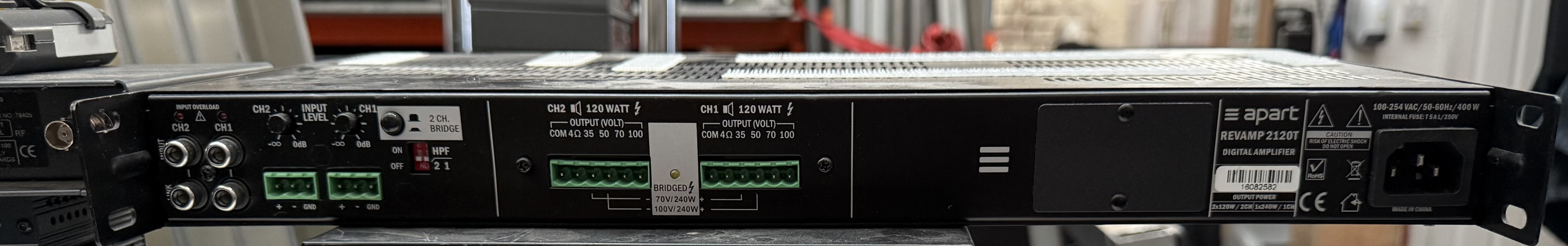 Rear connections of the Apart REVAMP 2120T amplifier showing RCA, balanced inputs and speaker outputs