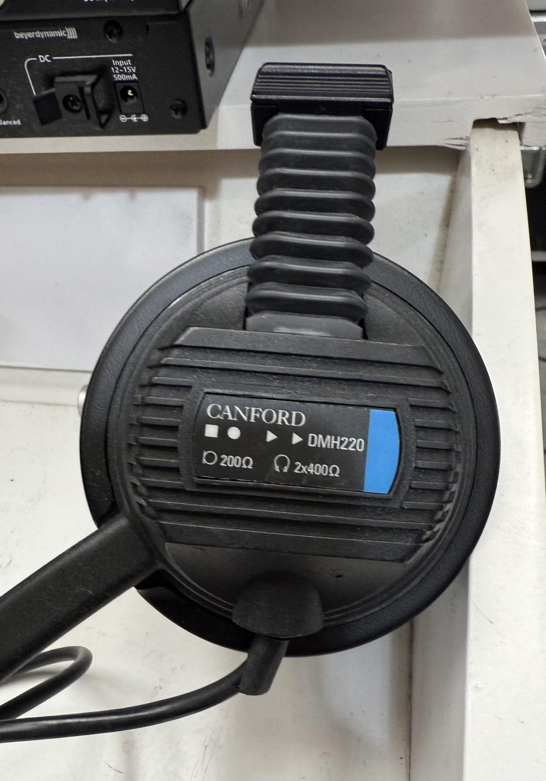Close-up of Canford DMH220 headphone model label showing 200 ohm and 2 x 400 ohm markings