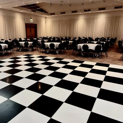 Large black and white dance floor in a draped room