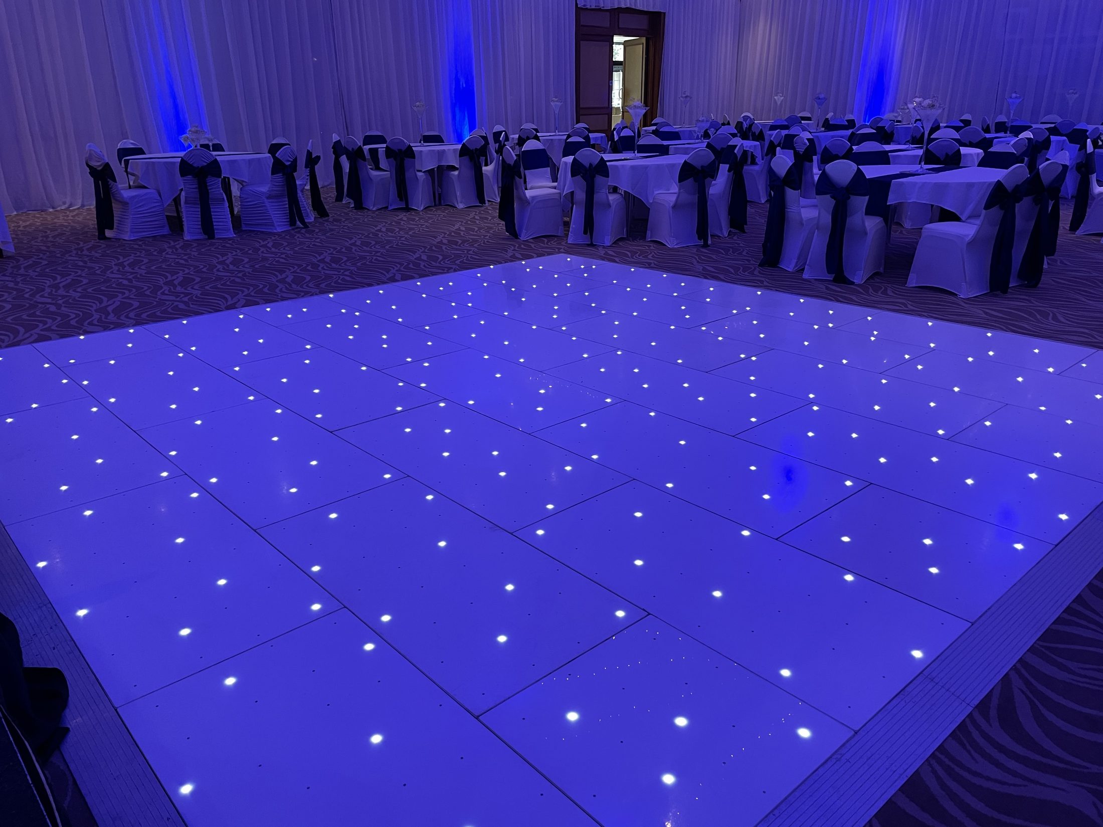 White starlight dance floor with blue uplighting