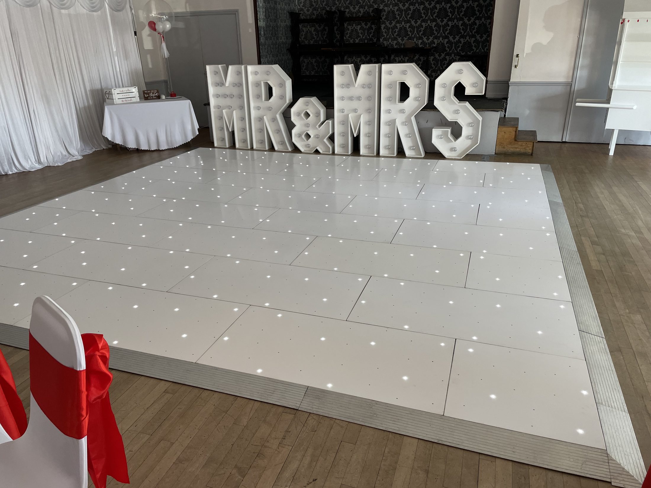 Large white starlight dance floor with Mr and Mrs letters