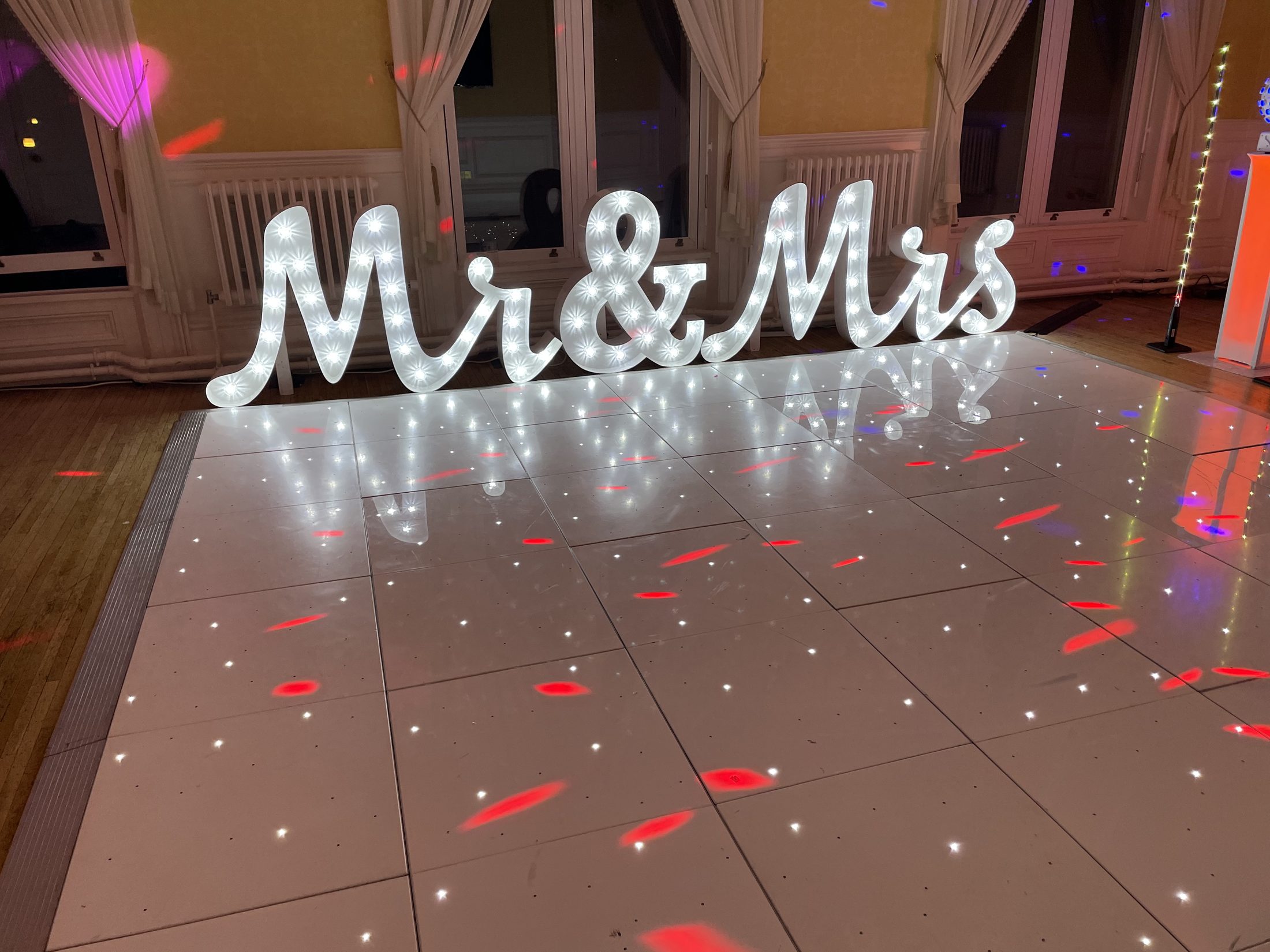 White starlight dance floor with illuminated Mr and Mrs letters