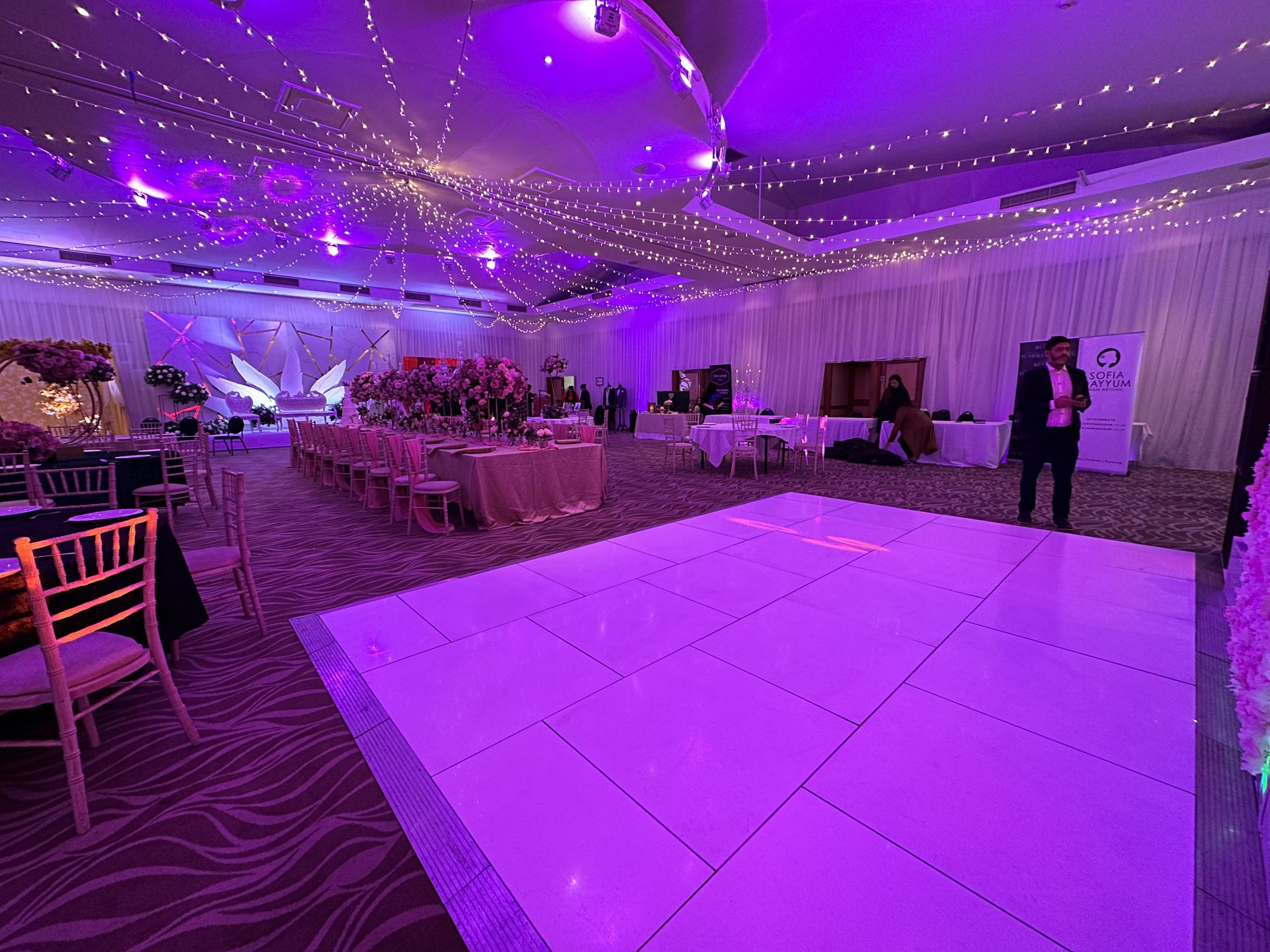 White dance floor with purple event lighting