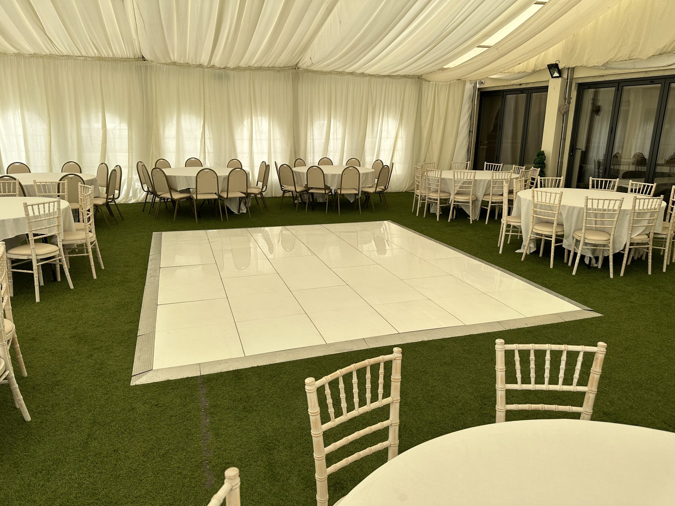 White dance floor inside a marquee