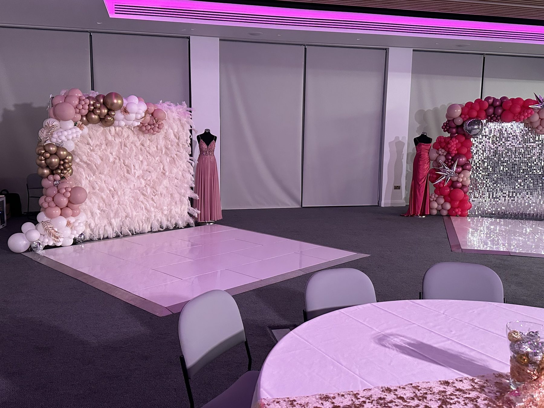 White dance floor with pink lighting, balloon backdrop and party decorations in Birmingham