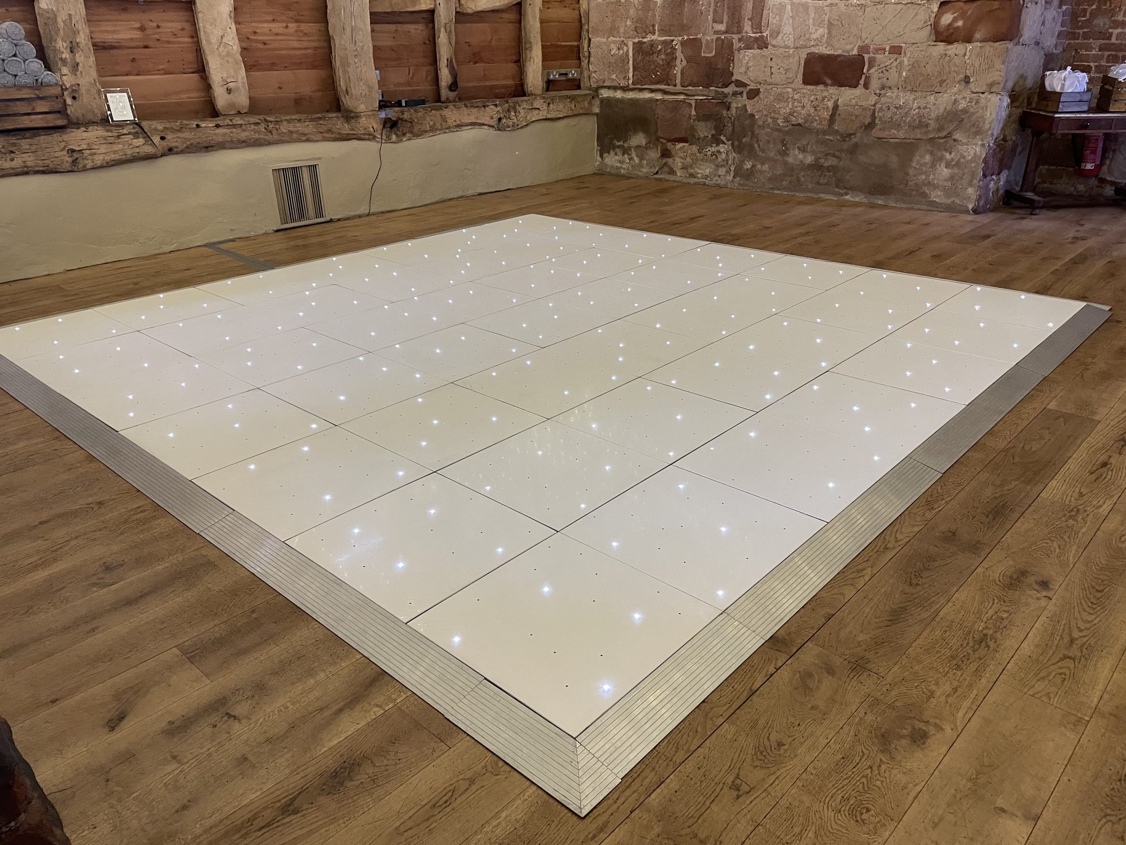White starlight dance floor in a barn venue