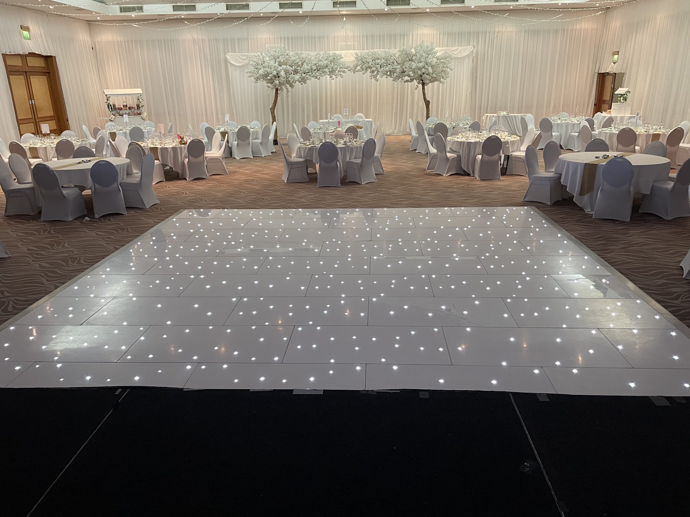 White starlight dance floor in a dressed wedding room