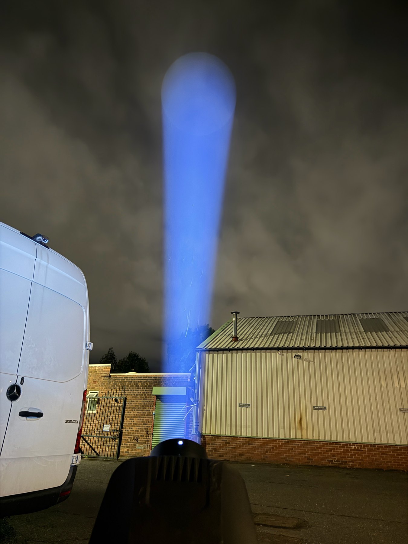 Black 400 watt gobo projector testing a bright blue beam