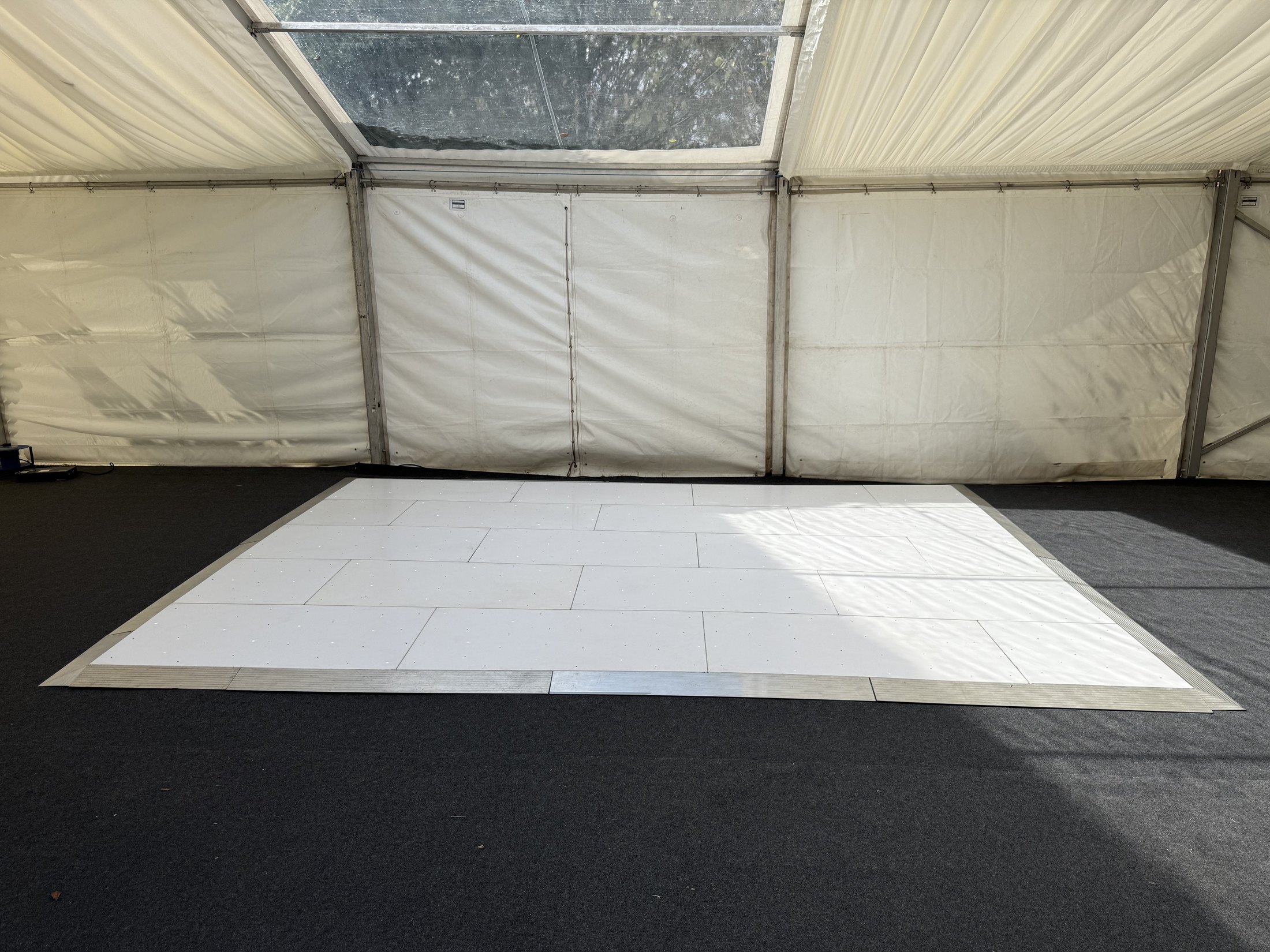 White starlight dance floor setup inside a marquee for an Asian home engagement party