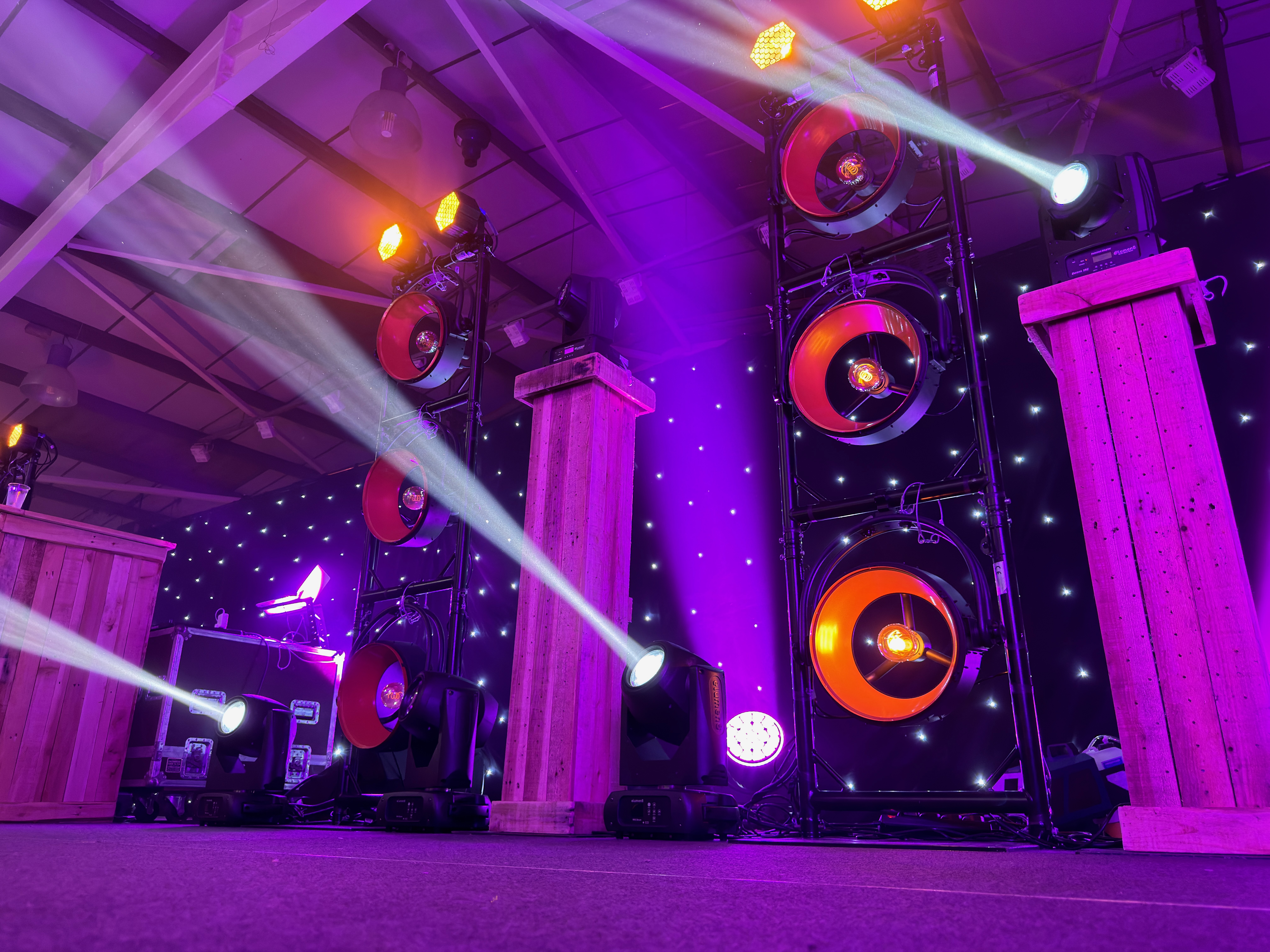 Busfest stage lighting at Malvern Showground with purple wash, moving beams and rustic podiums