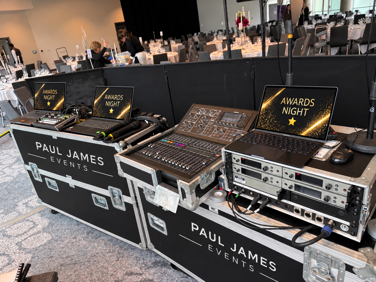 Technical control position with microphones, mixer, laptops and playback equipment for a business awards night