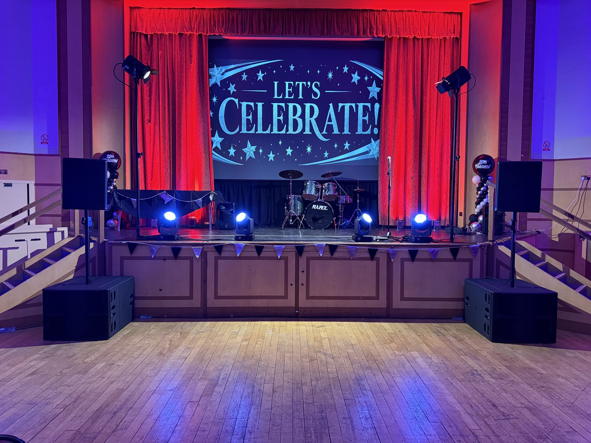 Wide view of the stage, Nexo sound system and moving head lighting at Dudley College