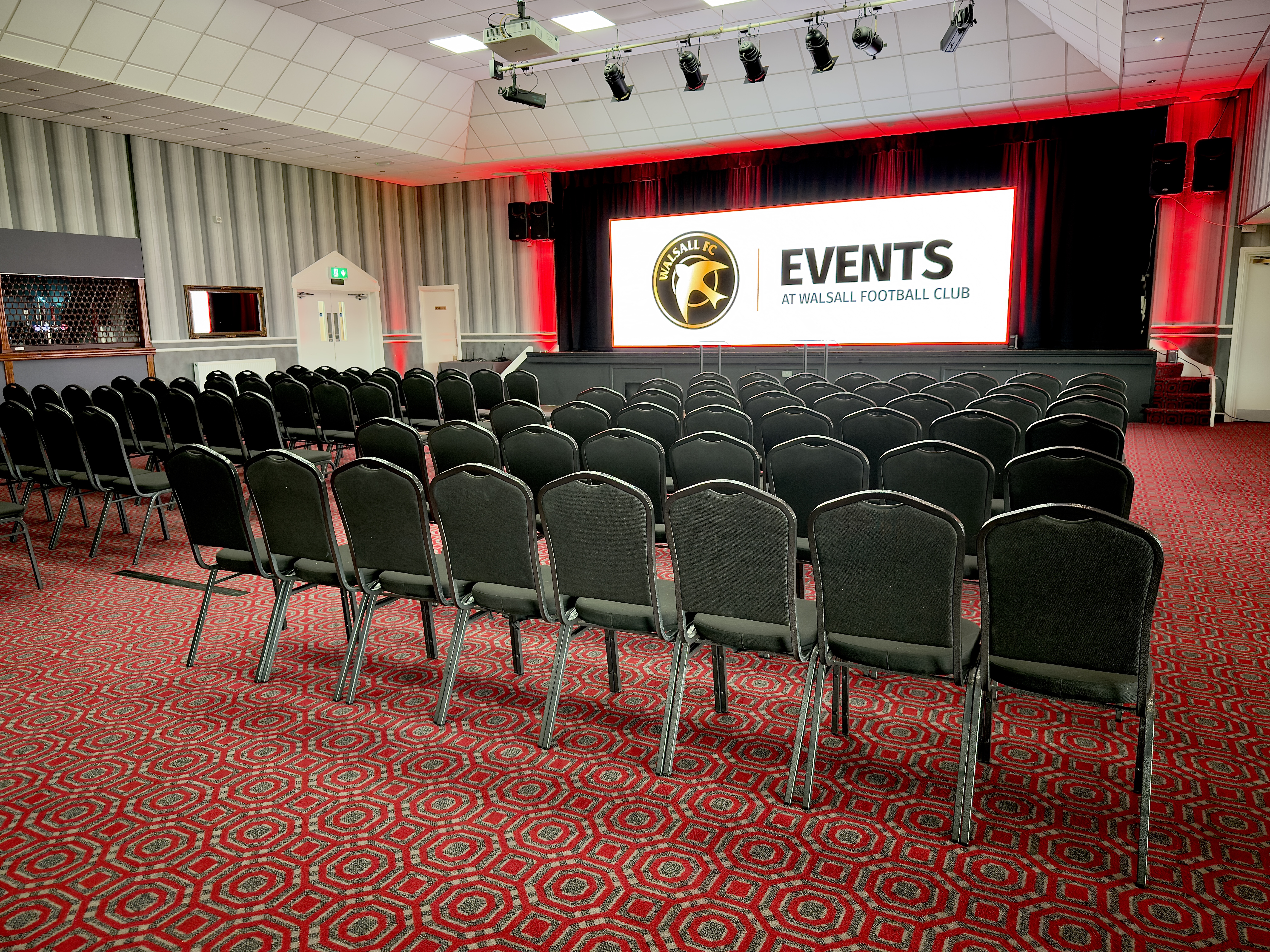 Venue event setup with screen, sound and lighting production