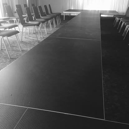 Black catwalk runway setup with seating