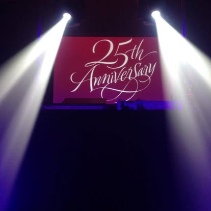25th anniversary image projection with spotlight beams