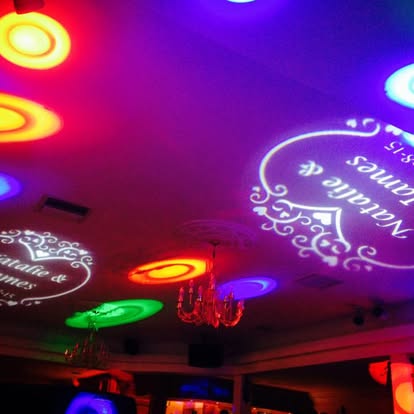 Coloured gobo projections across a venue ceiling