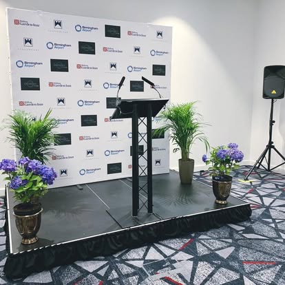 Lectern on a stage with branded backdrop