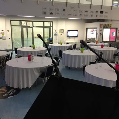 Lectern view across round tables in an event space