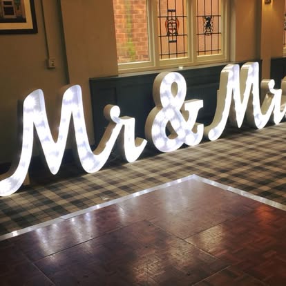 Close-up of Mr and Mrs illuminated letters by a dance floor