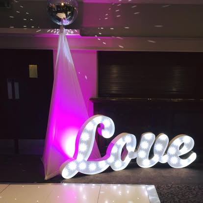 Love illuminated letters with disco ball lighting