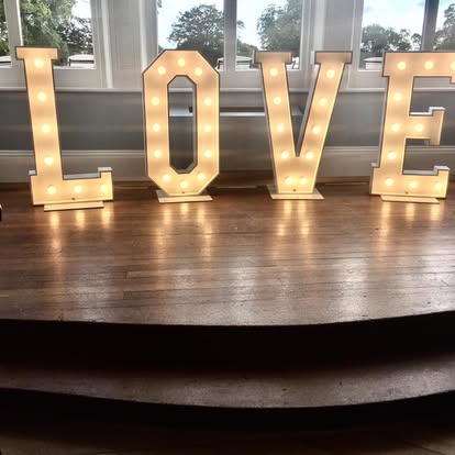 Warm white LOVE letters on a stage