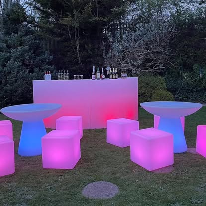Pink and blue LED furniture in an outdoor lounge setup