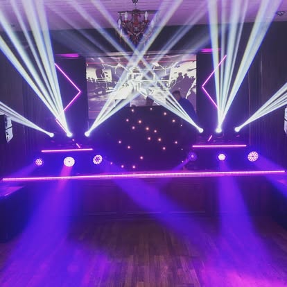 DJ booth with stage beams and neon framing