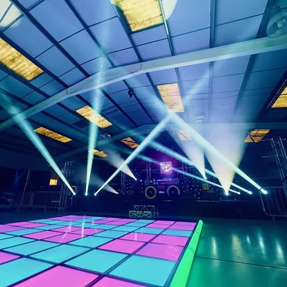 Large lit dance floor with overhead beams