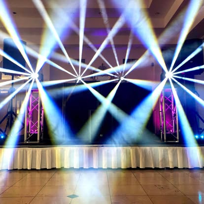 Bright stage beams over a dance floor