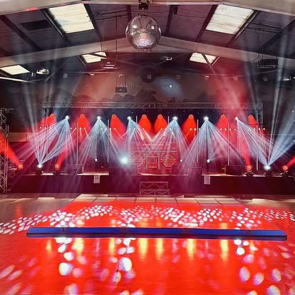 Wide red and white lighting rig over a dance floor