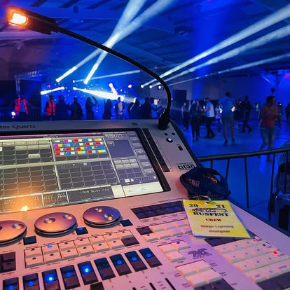 Lighting desk view over a live event