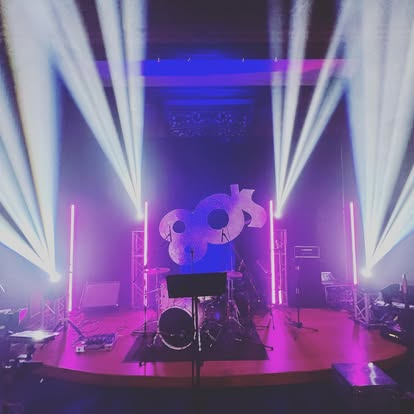 Live band stage with pink accent lighting