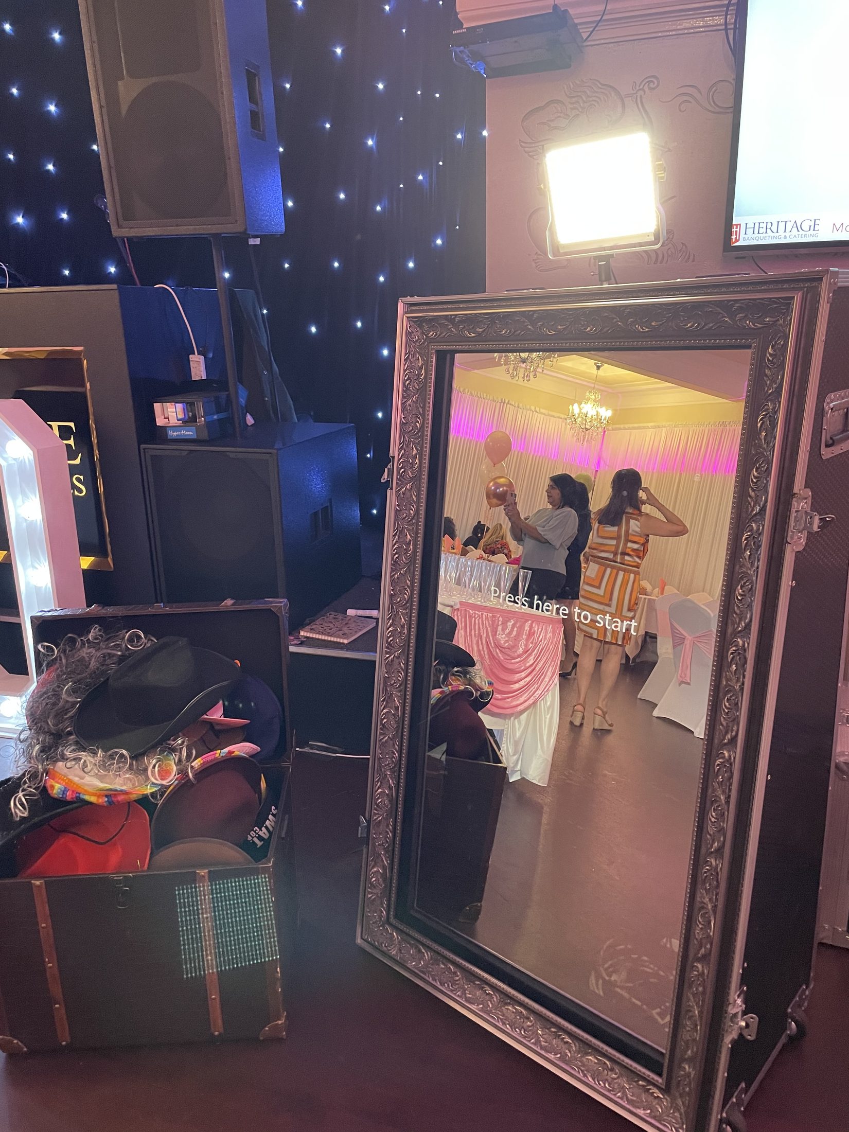 Ornate Magic Mirror photo booth with studio light and party guests