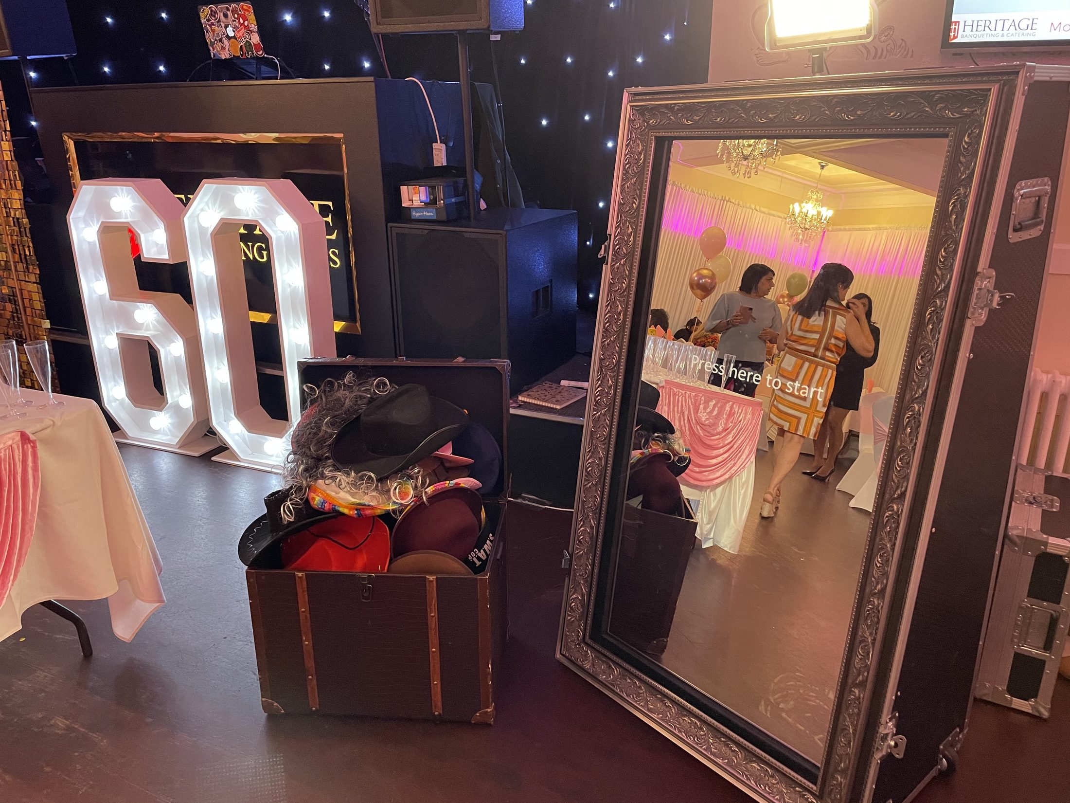 Magic Mirror photo booth with illuminated 60 numbers and dressing-up props at a birthday celebration