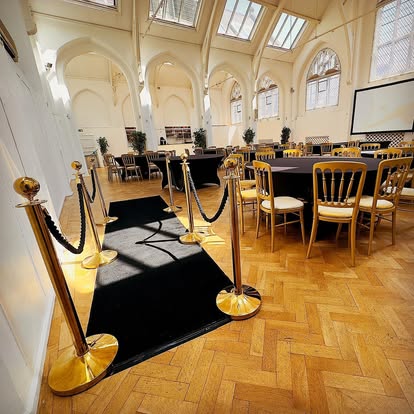 Small event venue with carpeted entrance and tables