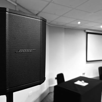 Bose speaker and projector screen in a small room