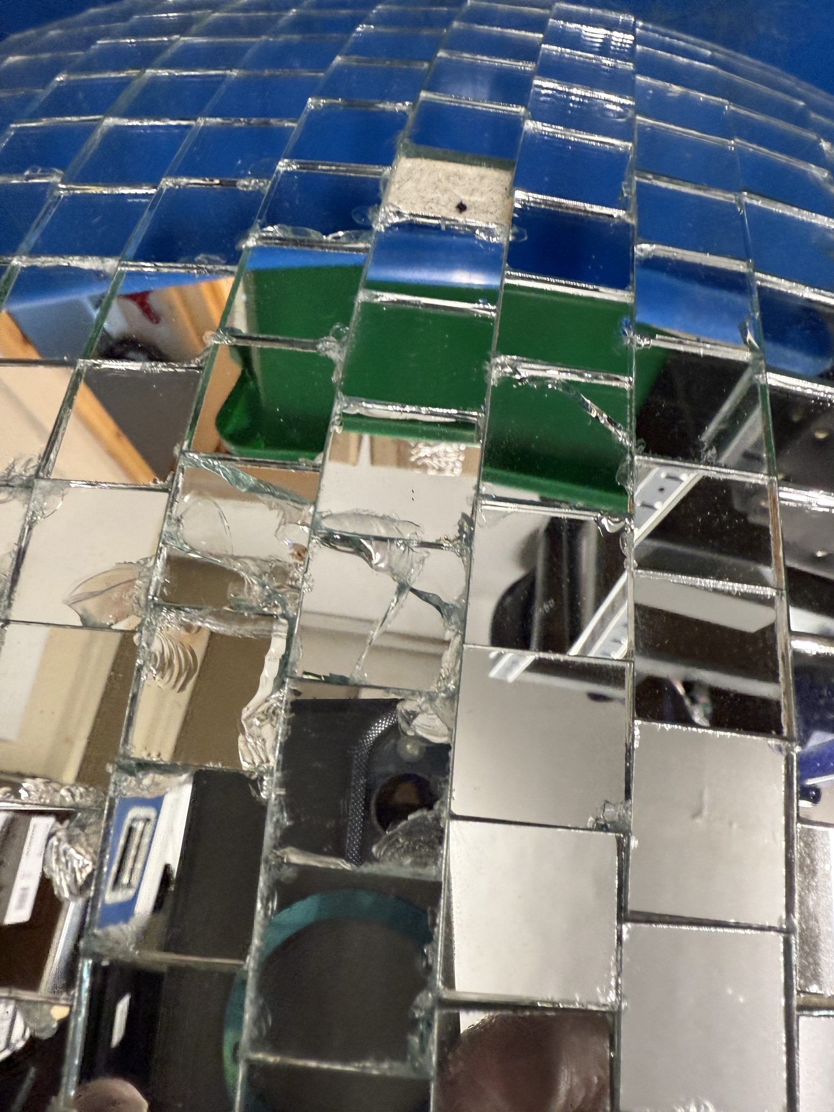 Close-up of slight damage to the mirrored tiles on one 60cm mirror ball