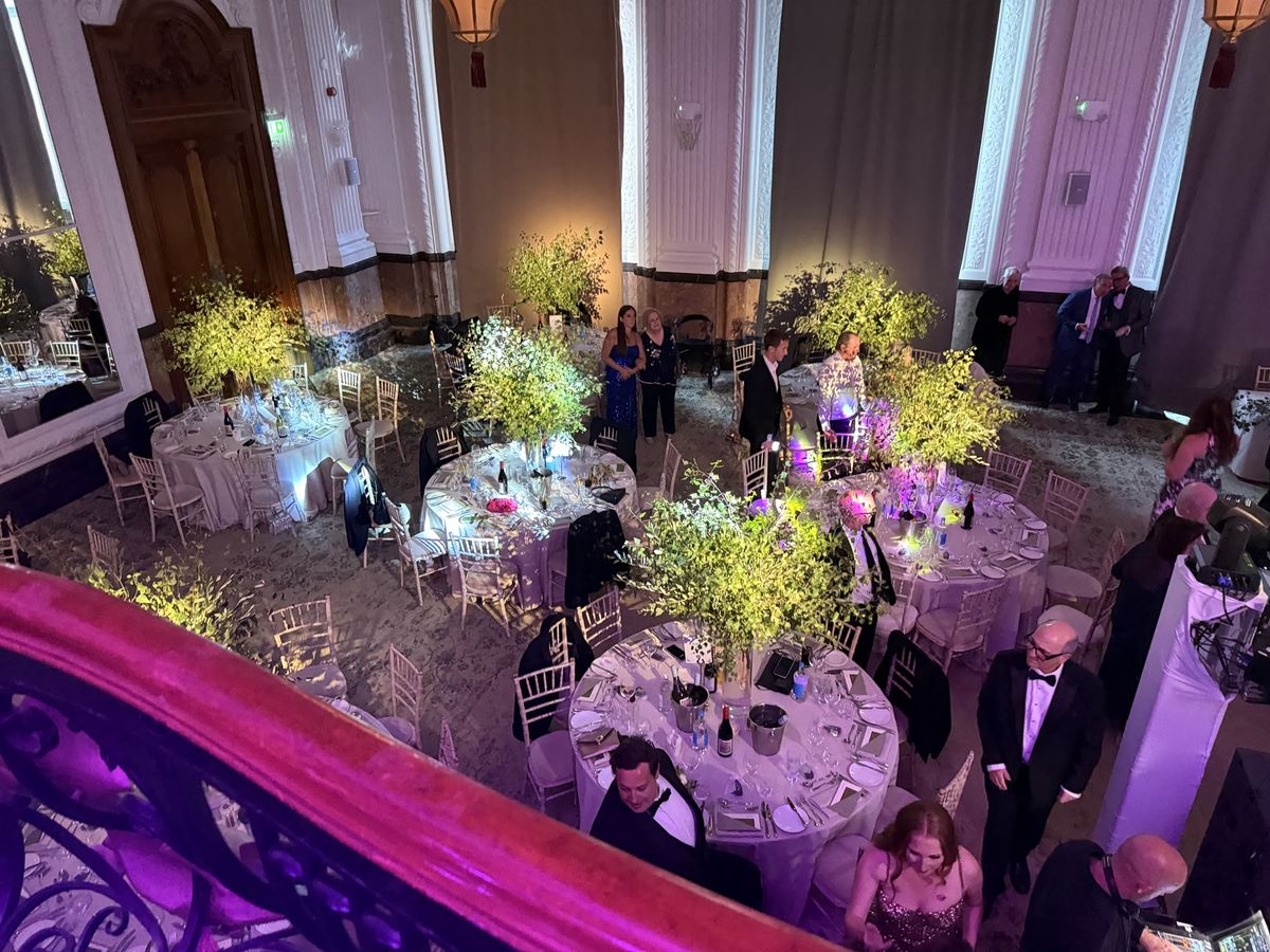 Elegant banquet tables highlighted with professional event lighting