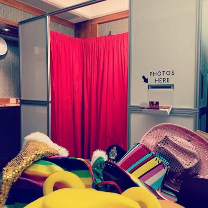 Photo booth with curtain backdrop and props