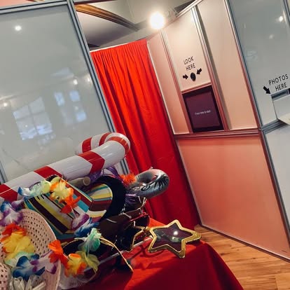 Photo booth with props and red curtain