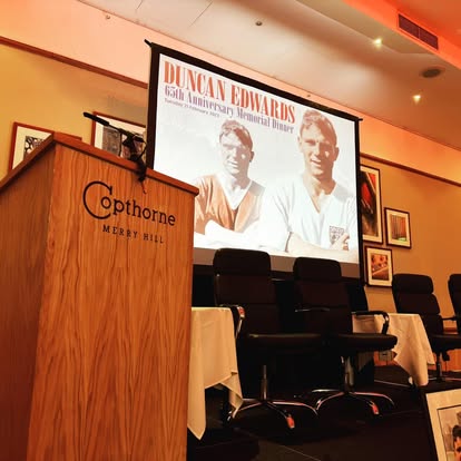 Projection screen behind a lectern setup