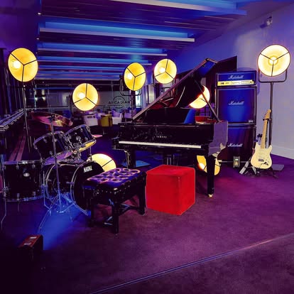 Movie spotlights around a piano stage