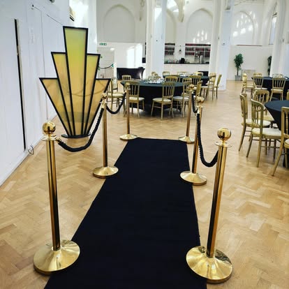 Black carpet entrance with art deco prop panel