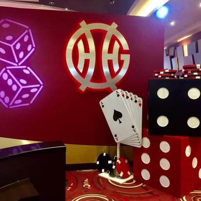Casino backdrop with giant card and dice props