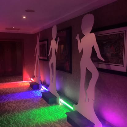 Silhouette props lit with colourful event lighting