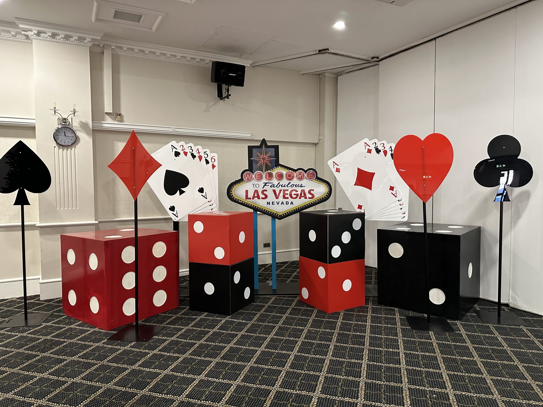Las Vegas party props with giant dice, card suits, playing cards and illuminated sign