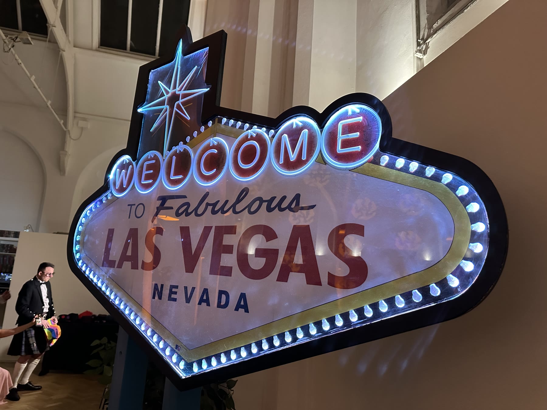 Illuminated Welcome to Fabulous Las Vegas sign prop glowing blue at a themed event