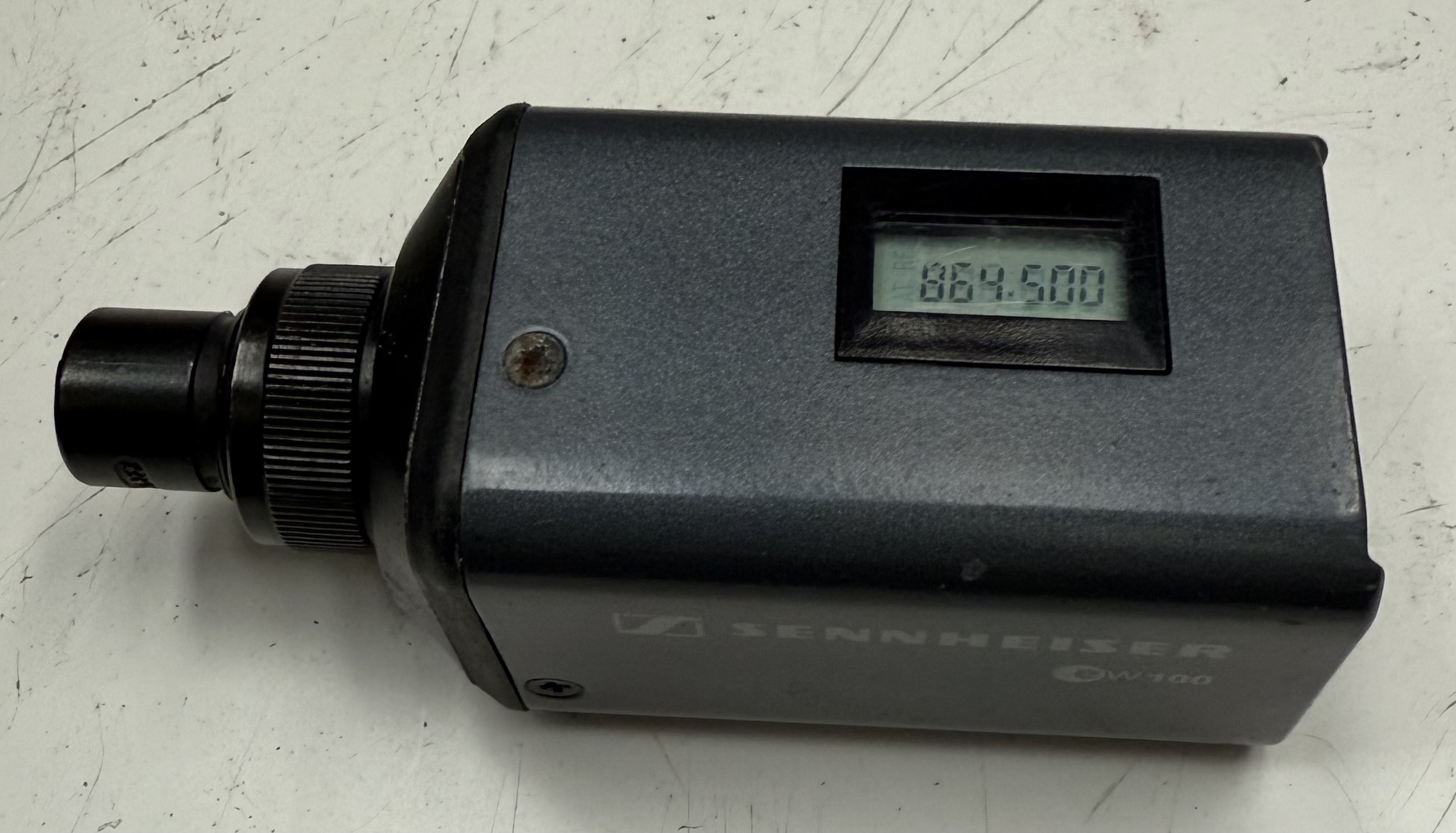 Sennheiser SKP 100 transmitter display showing 864.500 MHz