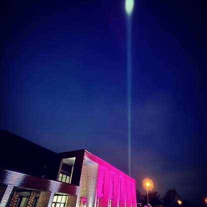 Single sky beam above a lit building